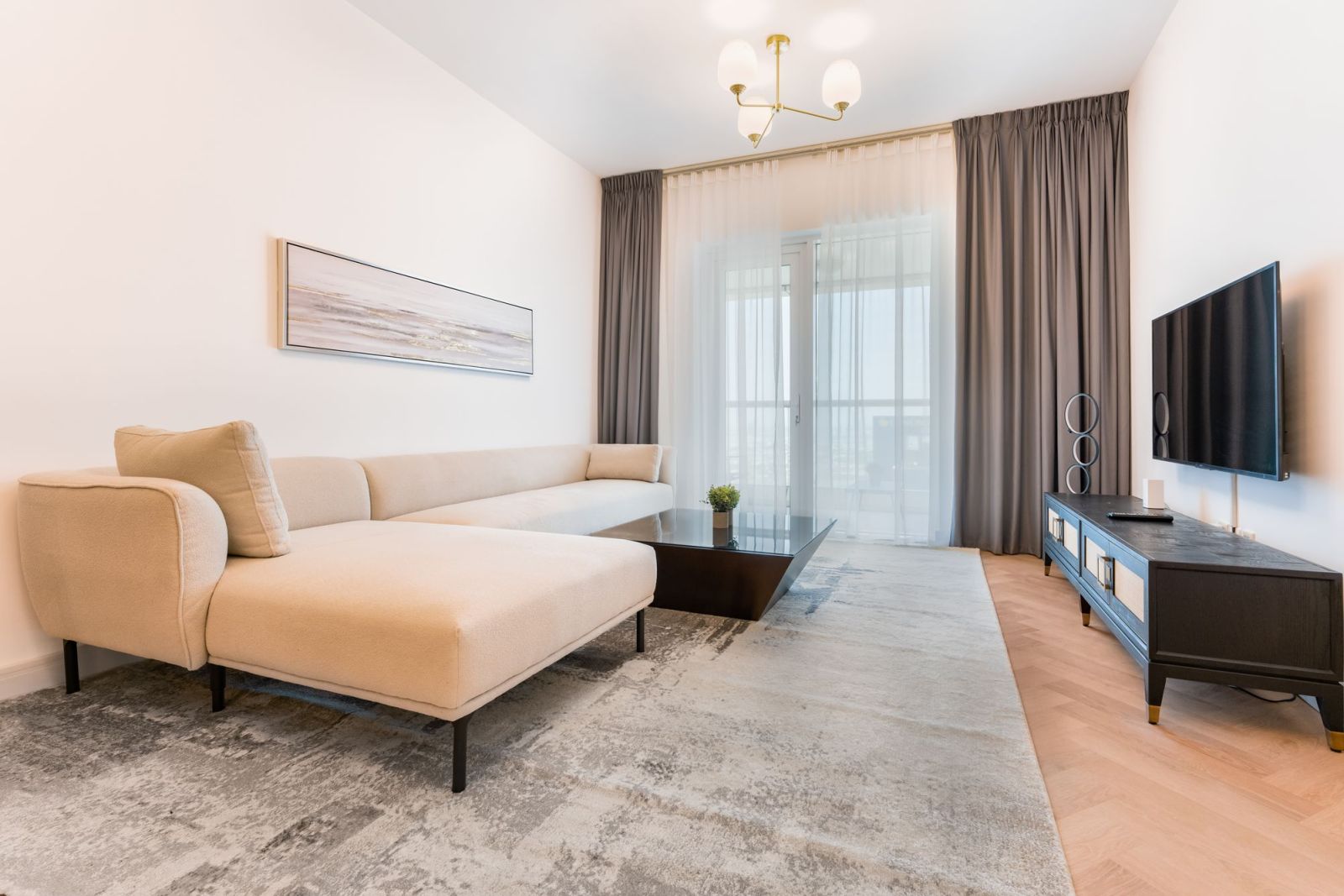 A calm, tidy living room with a cream sofa and soft daylight