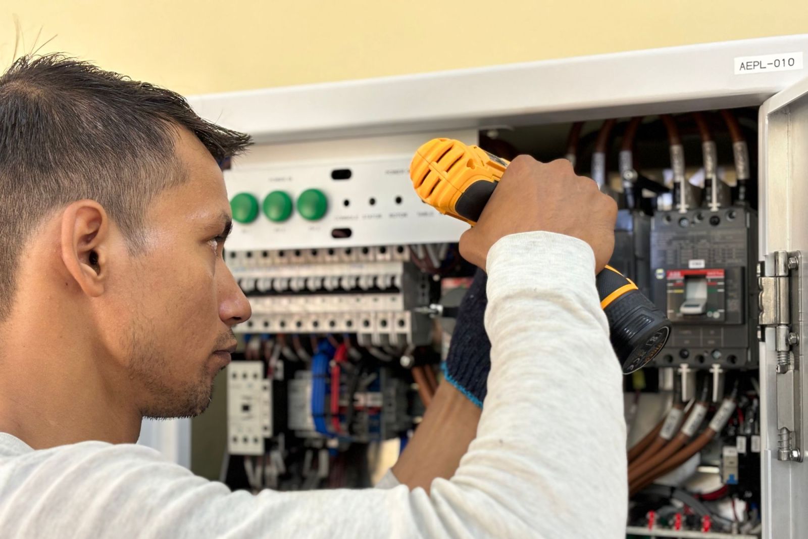 An electrician working on a consumer unit