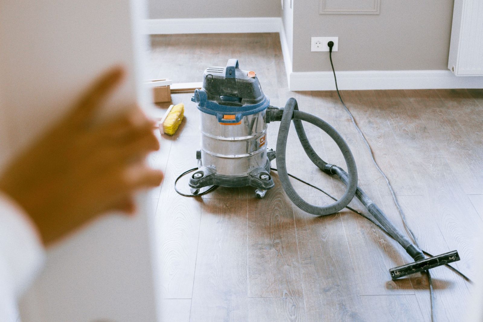 A builder's vacuum on a new wooden floor after renovation work